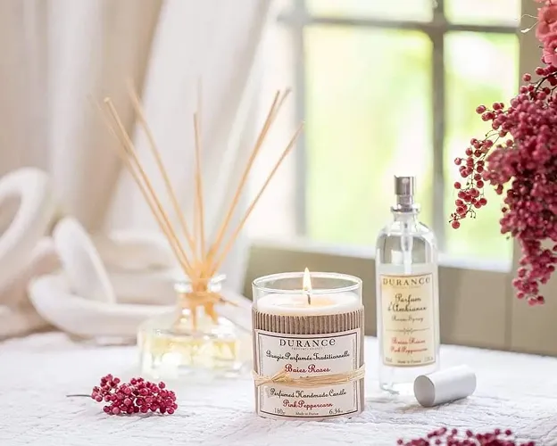 Candle parfumée roses et diffuseur d'huiles essentielles élégants sur table décorée